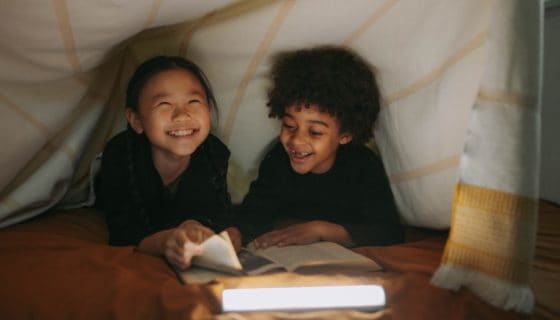 two children in a bed fort