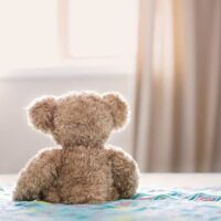brown-bear-plush-toy-on-bed-860882